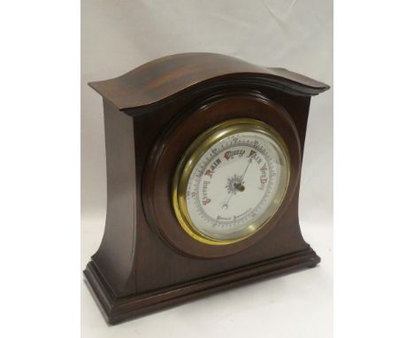 A good quality aneroid barometer with circular dial in arched mahogany case 14½" high
