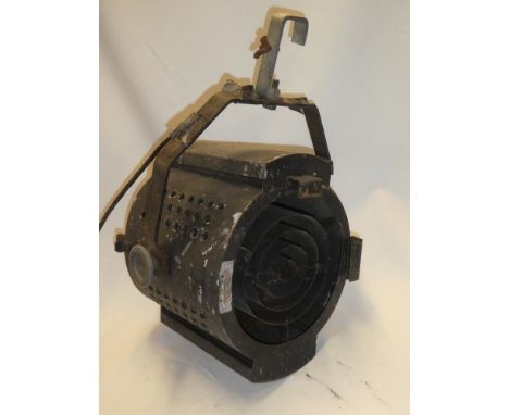 A vintage painted metal studio spot lamp on mounting bracket