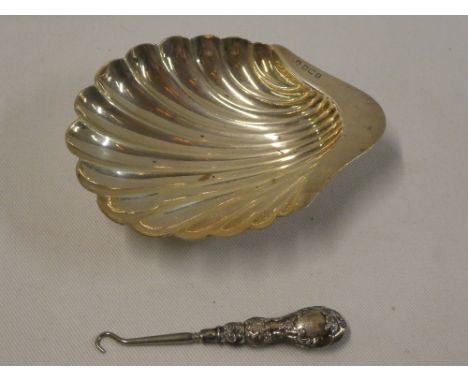 A silver scallop-shaped sweet meat dish, Sheffield marks and a silver handled button hook (2)