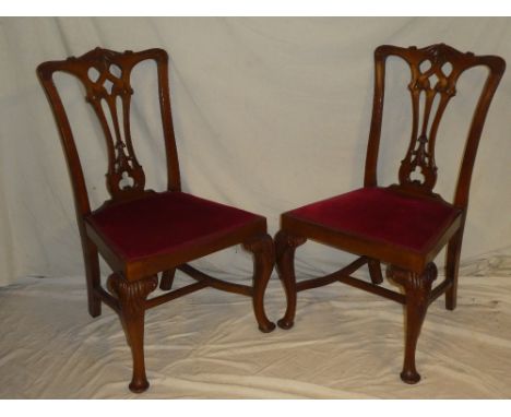 A set of six mahogany Chippendale-style dining chairs with pierced vase splat backs and upholstered seats on cabriole legs