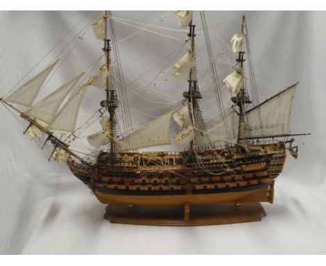 A wooden scale built model of HMS Victory with deck detail, 42" long together with additional cross section model showing gun