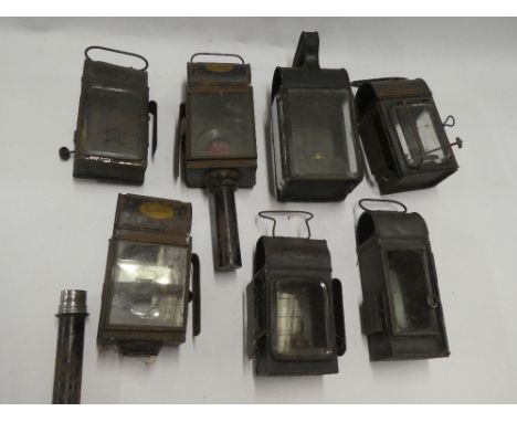 A selection of various vehicle oil lamps including hanging railway-style lamps, trap lamp and others etc.