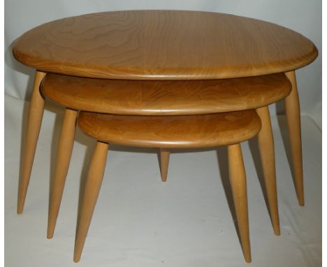 A nest of Ercol light elm "Pebble" occasional tables on tapered legs