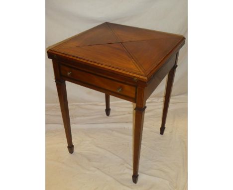 A late Victorian/Edwardian inlaid mahogany square envelope-shaped card table with folding top and a single drawer in the frie