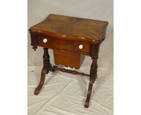 A late Victorian inlaid mahogany turnover top games/work table, the top opening to reveal chess and backgammon boards above a