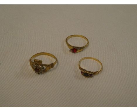 A 9ct gold dress ring with clasped hands emblem set ruby and diamond chips and two other various 9ct gold dress rings (3)