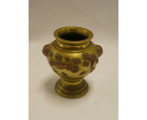 A small 19th century Japanese bronze tapered vase with raised figure head and floral decoration 3½" high