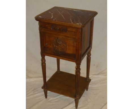 A French walnut bedside cabinet with pink veined marble top above a single frieze drawer and ceramic lined cupboard on turned