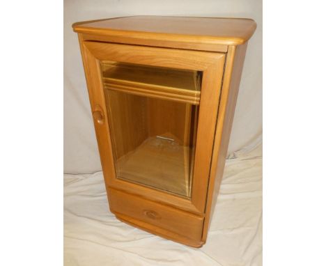 A good quality Ercol light elm hi-fi cabinet with base drawer, shelves enclosed by a single glazed door and hinged top 36" hi