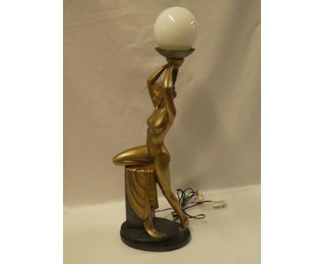 A modern plaster Art Deco-style table lamp in the form of a nude female supporting a glass spherical shade 28" high overall