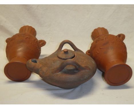 A pair of Eastern terracotta tapered vases with dragon decorated handles, 10" high and one other terracotta Roman-style oil l