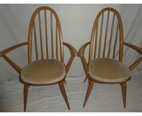 A pair of Ercol light elm hoop-back carver dining chairs