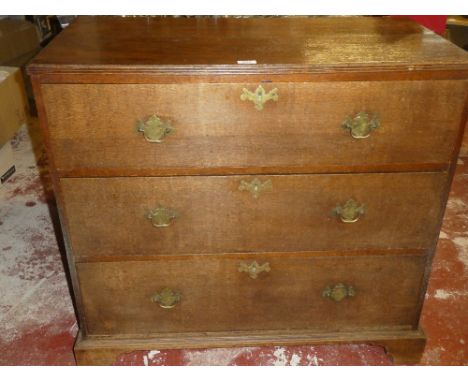 A 19th Century oak chest of three long drawers with brass ring handles on bracket feet
