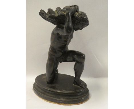 An old bronze figure of a crouching nude male holding a scallop bowl aloft on oval base 7½" high