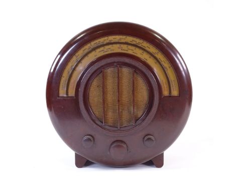 An EKCO model AD65 wood-effect Bakelite radio, 1934 design, by Wells Coates for E K Cole Ltd, height 16"