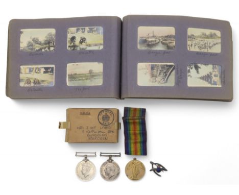 A WW1 medal pair awarded to S-25700 Pte. D.T. Laing, Royal Highlanders, a WW2 War Medal, a medal issue packet addressed to Mr