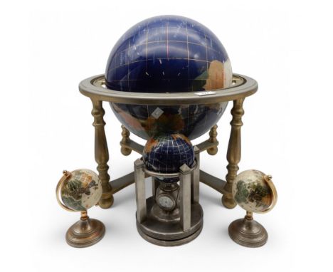 A large hardstone globe of the world, a smaller example with barometer and clock to base and a further two miniature examples