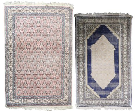 A pink geometric patterned ground Persian style rug with cream border, 180cm long x 120cm wide and another dark blue ground r