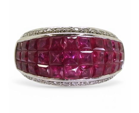 A ruby and diamond ring, mounted in 18k white gold, with a three row panel of tile set square cut rubies, with an accent of b