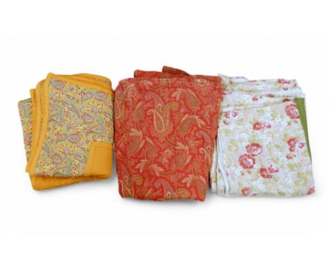 A double sided Comfy Quilt in orange and paisley fabric, a red paisley quilt and a rose decorated bed cover Condition Report: