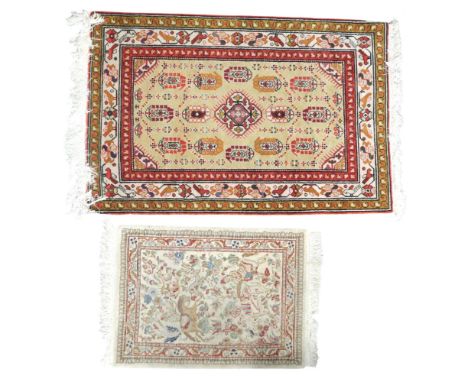 A lot comprising a beige ground Persian style rug with multicoloured geometric patterned ground within multiple floral patter