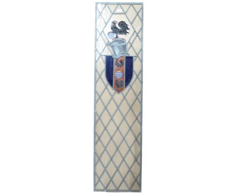 A 20th century armorial leaded stained glass panel decorated with armorial shield bearing two cockerels separated by waves un