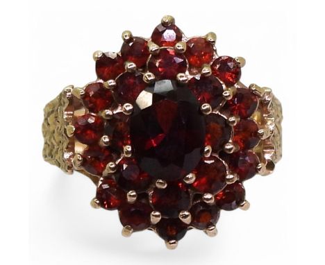A 9ct gold retro garnet flower ring, hallmarked 1977, size K, weight 4gms Condition Report:Available upon request