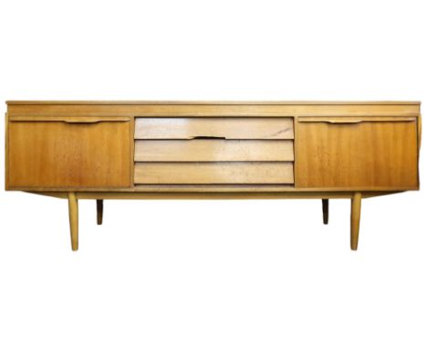 A mid 20th century teak Morris of Glasgow sideboard with three central drawers flanked by fall front drinks compartment to le