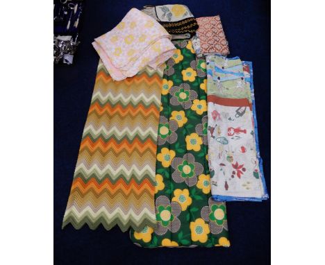 A retro 1970's sleeping bag, a crochet blanket with zig zag edge, a bed cover made up from 1950's and other fabrics, a knitte