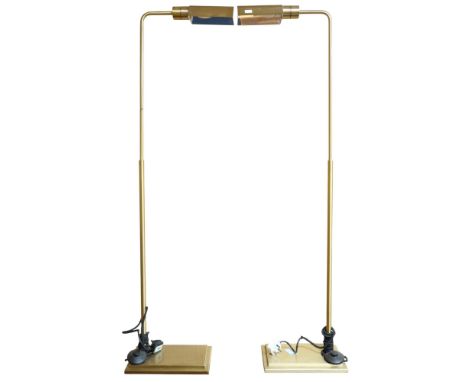 A pair of contemporary Chelsom brass toned free standing reading lamps with adjustable lamp shades on rectangular stepped bas