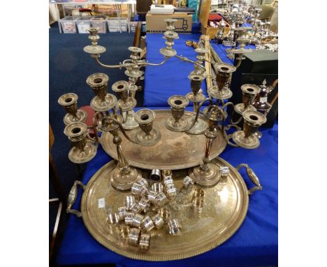A pair of EPNS five light candelabra, a pair of three light candelabra, two large oval serving trays with engraved decoration