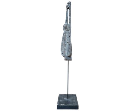 A&nbsp; polychrome wooden canoe prow, Papa New Guindea, profusely carved with geometric shapes, mounted on stand and plinth, 