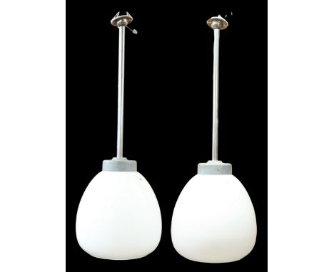 A pair of mid to late 20th century industrial style ceiling light fixtures with white opaque glass shades, 79cm high x 27cm d