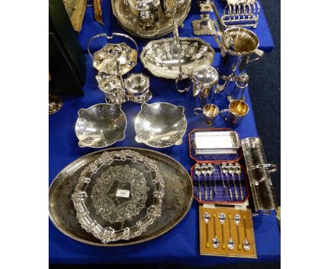 A collection of EPNS including swing-handled baskets, an ice bucket with celtic knotwork decoration, a salver, an oval tray, 