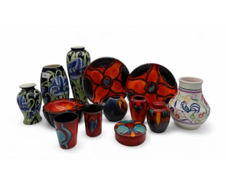 A collection of Poole pottery in orange and red glaze, together with a flower and bird decorated Poole vase and a trio of tub