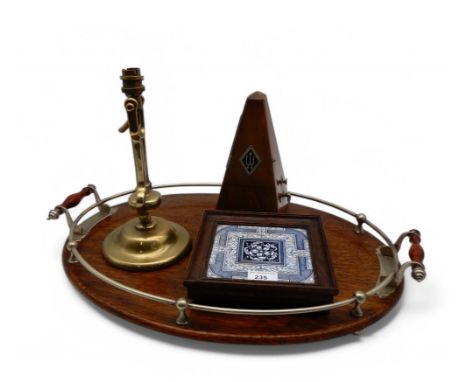 An oval oak tray with silver plated galleried mount and handles, a metronome, a ships brass gimble lamp and a tile pot stand 