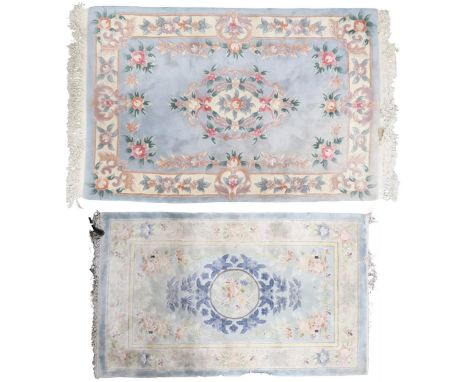 A lot consisting a pastel blue floral patterned rug with cream floral patterned central medallion and border, 190cm long x 12
