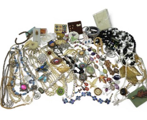 A large collection of costume jewellery to include vintage brooches, carved antler brooches, micro mosaic brooches to include