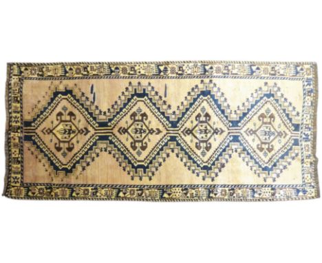 A BEIGE GROUND BALUCHI FINE PILE WOOL RUNNER&nbsp; with four dark geometric diamond shaped medallions within geometric patter