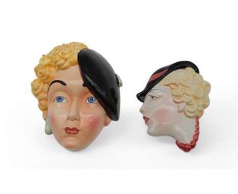 An Art Deco Beswick wall mask of a girl with curly blonde hair, wearing a beret, no 314 together with a C &amp; Co wall mask,