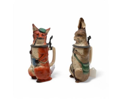 A pair of late 18th/early 19th century German steins, one modelled as a fox holding a stein and smoking a long pipe, the othe