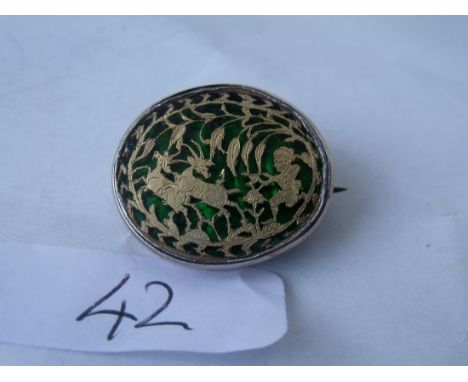 Gold and green foil back brooch depicting  a hunting scene       