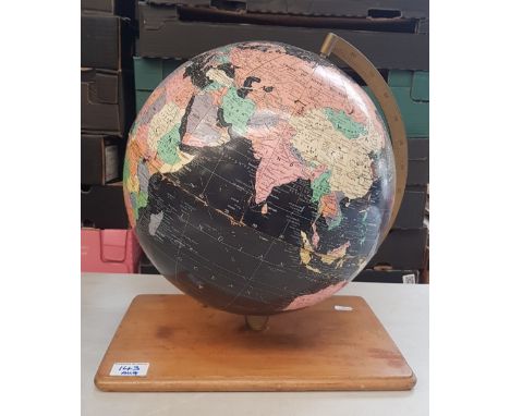 Vintage globe on wooden base, 38cm in height. 
