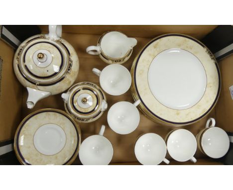 A collection of Wedgwood Cornucopia tea and dinnerware to include cups, saucers, teapot, lidded sugar bowl, teapot, dinner pl