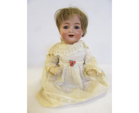 A Kammer &amp; Reinhardt bisque head character doll with blue glass sleeping eyes, open mouth and teeth, brown mohair wig, co