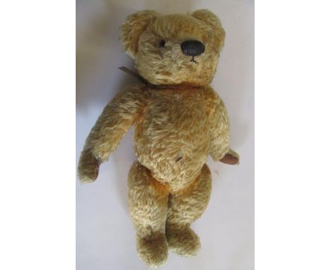 A Chad Valley teddy bear with swivel joints, growl, gold plush, black/amber eyes, sewn nose, felt pads, labels to chest and f