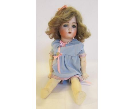 A Kammer &amp; Reinhardt bisque head doll with blue glass sleeping eyes, open mouth and teeth, brown mohair wig, jointed comp