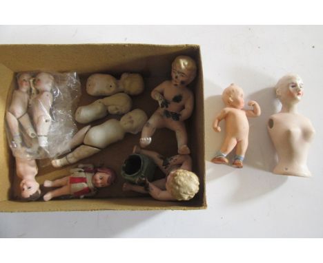 Twelve all bisque dolls, some only part complete, 5 1/2" high maximum, including two Kewpie dolls (Est. plus 21% premium inc.