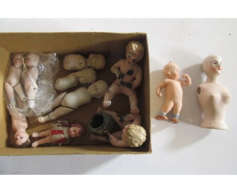 Twelve all bisque dolls, some only part complete, 5 1/2" high maximum, including two Kewpie dolls (Est. plus 21% premium inc.