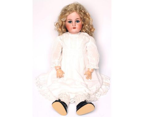 A Kammer &amp; Reinhardt bisque head doll with blue glass sleeping eyes, open mouth and teeth, pierced ears, later blonde moh